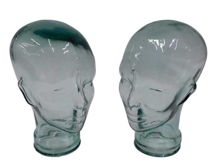 A pressed moulded glass head, 26cm high, and another similar. (2)