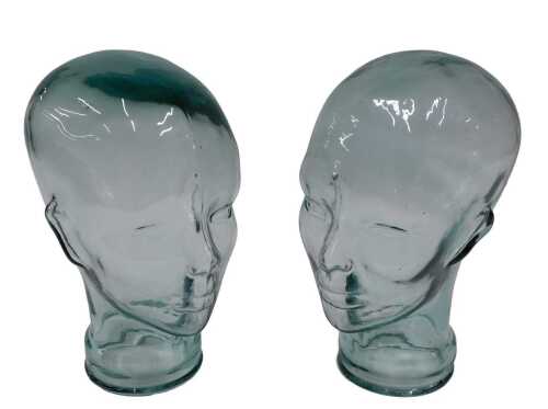 A pressed moulded glass head, 26cm high, and another similar. (2)