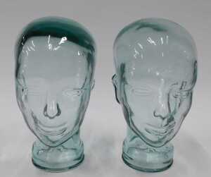 A pressed moulded glass head, 26cm high, and another similar. (2) - 2
