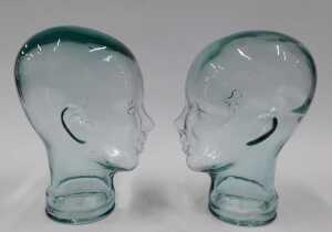 A pressed moulded glass head, 26cm high, and another similar. (2) - 3