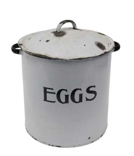 An early 20thC enamel bin and cover, marked EGGS, in black and white, with removable lid, 31cm...