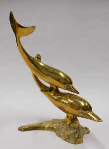 Brassware, a Dolphin group, 35cm high, and an Eastern vase with flared rim and shouldered body. (2) - 2