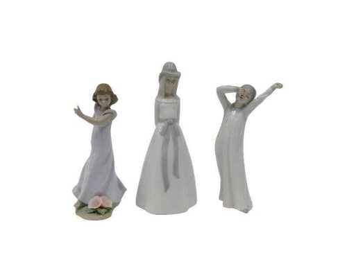 A Lladro figure group child aside flowers, 6990, 20cm high, a Nao yawning child and a Valencia...