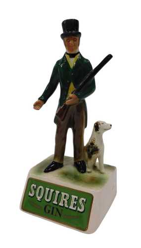 A Squire's Gin pottery pub advertising figure group, man holding rifle aside dog, 27cm high.