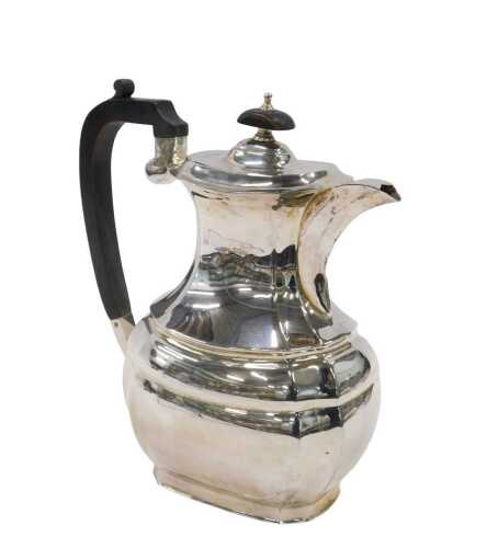A George VI silver coffee pot, of inverted oval form with thumb mould, ebonised handle and...