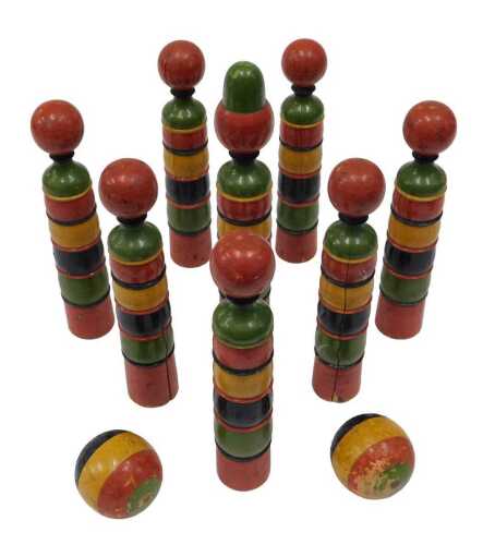 An early 20thC wooden skittle set, with orb tops, and vibrant coloured stems, 27cm high.