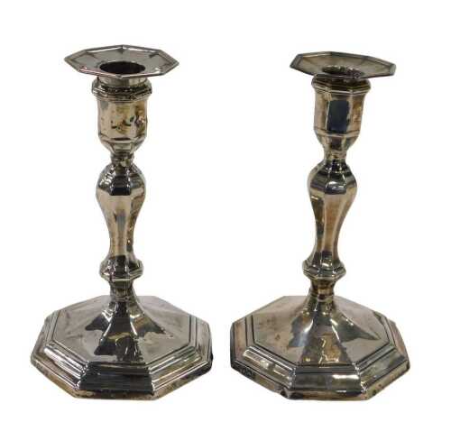 A pair of Victorian silver candlesticks, with octagonal dish holders, baluster stems, stepped...
