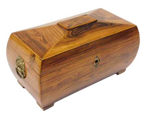 A Regency rosewood sarcophagus shaped tea caddy, the hinged lid with satinwood inlay, revealing...