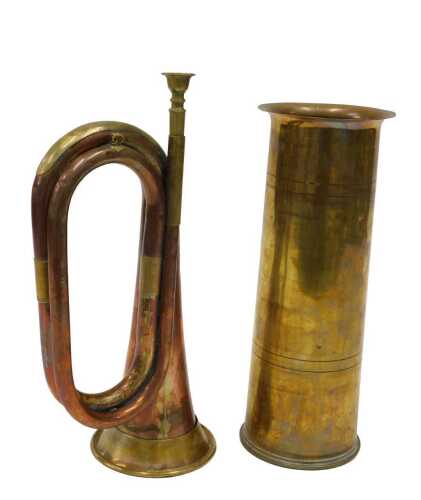 An early 20thC copper and brass bugle, 32cm high, and a shell case vase, numbered beneath. (2, AF)
