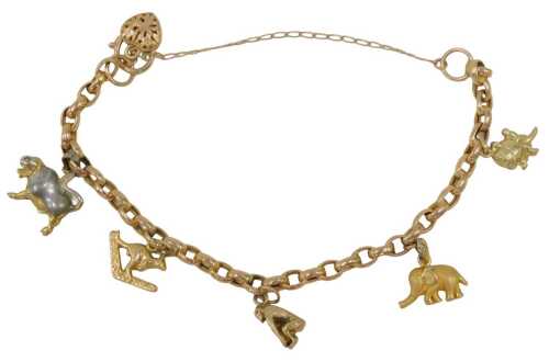 A charm bracelet, with a 9ct rose gold curb link bracelet with safety chain and heart shaped...