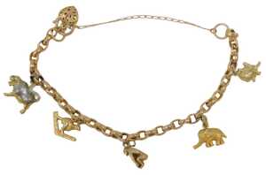 A charm bracelet, with a 9ct rose gold curb link bracelet with safety chain and heart shaped...
