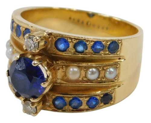 A sapphire, diamond and seed pearl dress ring, of three row design, the central raised round...