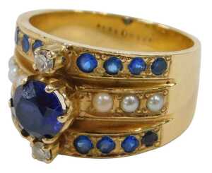 A sapphire, diamond and seed pearl dress ring, of three row design, the central raised round...