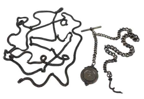 A graduated silver Albert watch chain, with T bar end, attached to a silver football fob...