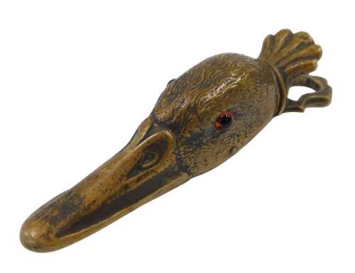 An early 20thC brass duck head paper clip, with articulated back, the eyes picked out in red...