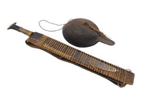 An early 20thC Eastern machete, possibly Chinese, with wooden and part brass handle, shaped...