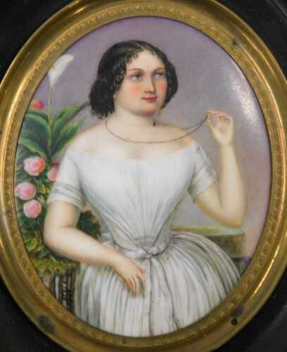 A 19thC Berlin porcelain plaque, painted with a portrait of a lady dressed in finery, 7cm x 5cm,...
