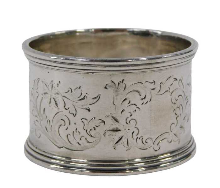 A George VI silver napkin ring, of circular form, part etched with scrolls, leaves and flower...