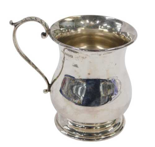 A George VI silver mug, of inverted circular form, with S scroll thumb mould handle, on circular...