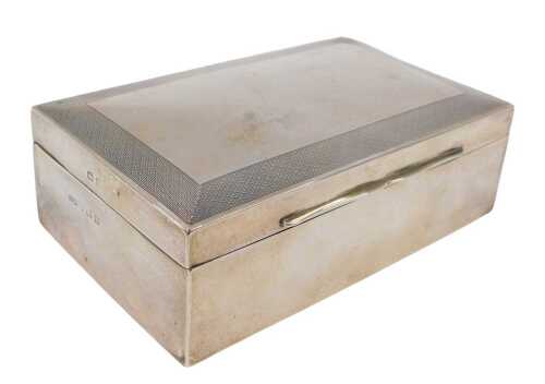 A George V silver cigarette box, of rectangular form, with engine turned border, thumb mould...