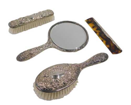 An Elizabeth II silver backed three piece dressing table set, comprising hairbrush, hand mirror...