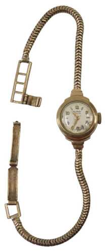 A 9ct gold cased Rotary lady's wristwatch, with a silvered baton and numeric dial, on linked...