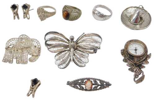 A group of silver jewellery, comprising a filigree butterfly brooch, an elephant butterfly...
