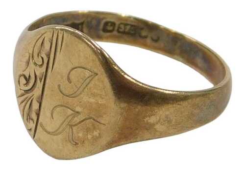 A 9ct gold signet ring, the oval ring head with part scroll design and bearing the initials JK,...