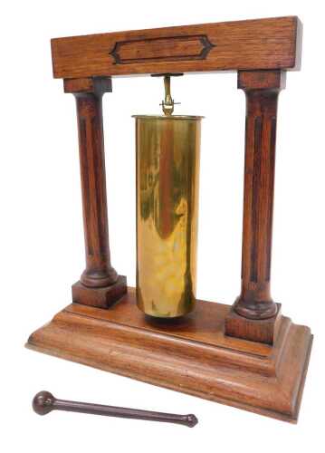 A dinner gong, made from a WWI German 7.7cm brass shell case, dated April 1916, with oak...