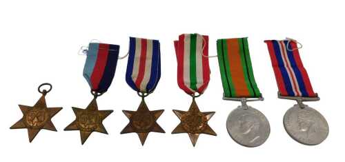 A group of WWII medals, to include a 39-45 star, Africa star, France and Germany star, Italy...