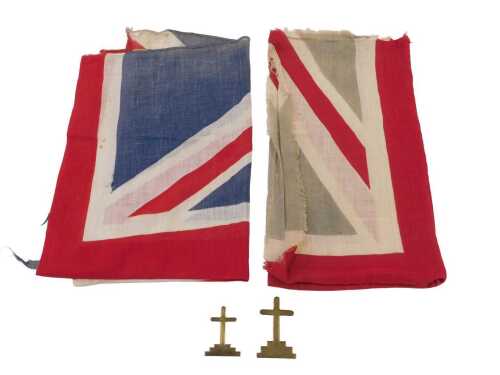 A handmade brass crucifix, 5.5cm long, together with another similar example, 6.5cm long, and...