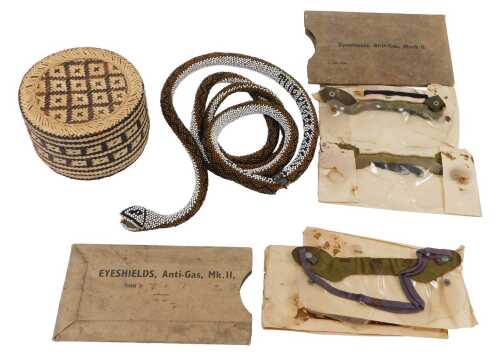 A First World War beadwork snake in a straw basket, made by a Turkish prisoner of war, together...