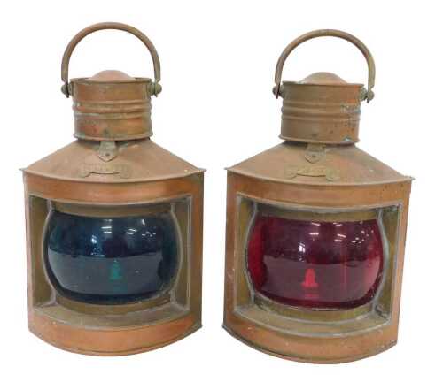 A pair of 20thC copper and brass ship's lanterns, of small size, each with swing handles,...