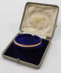 A 9ct rose gold half hinged bangle, with part floral design, 6cm diameter, 5.1g, boxed. - 5