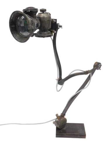 A retro table lamp, with Belio bicycle carbide acetylene lamp top, on hand forged articulated...