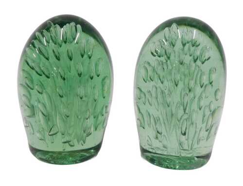 A pair of 19thC Stourbridge style green glass dumps, with flower head decoration, rough pontil.