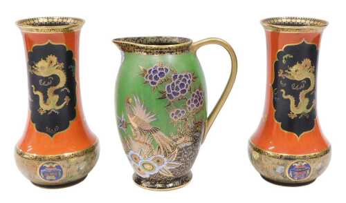 A pair of Carltonware W&R dragon lustre vases, decorated with panels of dragons on an orange...