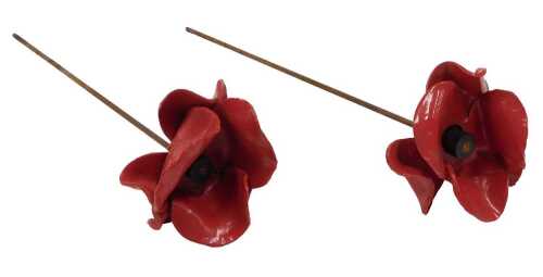 Two Paul Cummins design red ceramic Tower of London poppy sculptures, on metal stems, each 49cm...