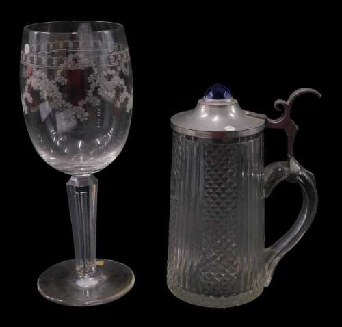An early 20thC cut glass flagon, hobnail cut with a repeat geometric pattern, with base metal...