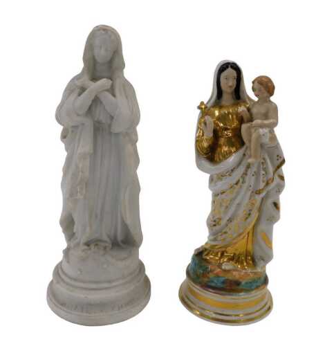 A 19thC porcelain figure group of the Virgin and Child, she in standing pose in floral dress and...
