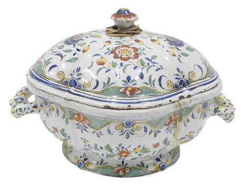 An 18thC French Faience lidded tureen, of shaped oval form, profusely decorated with flowers,...