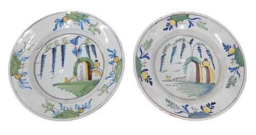 A pair of 18thC French Faience tin glazed earthernware plates, each of circular form, decorated...