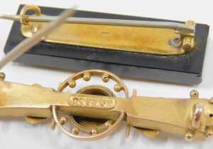 Two early 20thC bar brooches, comprising one centred with a garnet, yellow metal stamped 9ct,... - 2