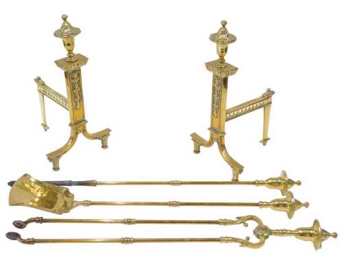 An early 20thC brass fireside companion set, comprising a pair of andirons, each with urn tops...
