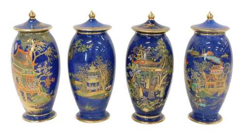 Four various Carltonware chinoiserie vases, typically decorated on blue ground with gilt...