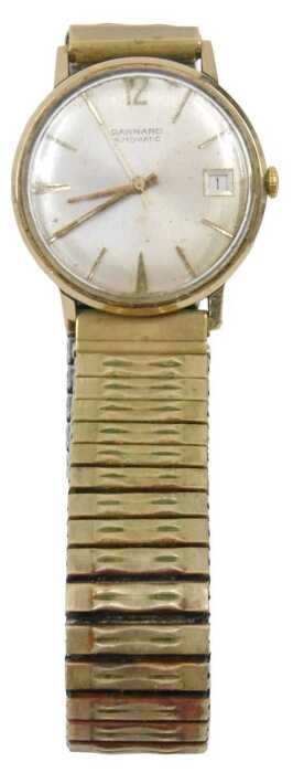 A Garrard 9ct gold cased gent's wristwatch, with a silvered baton dial with date aperture,...