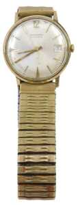 A Garrard 9ct gold cased gent's wristwatch, with a silvered baton dial with date aperture,...