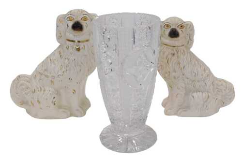 Two similar Staffordshire pottery spaniels, each with eyes picked out in yellow and gilt...