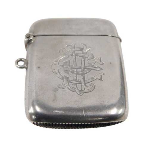 An Edward VII silver Vesta case, of oval form with hinged lid and ring side, with match strike...
