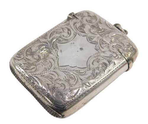 A Victorian silver Vesta case, the curved body heavily chased with scrolls, with a vacant shield...